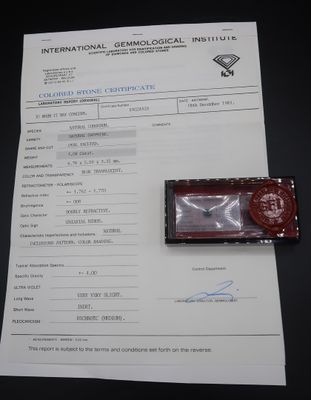 a red wax stamp sitting on top of a piece of paper