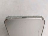 the back side of a silver iphone with a small hole in the middle