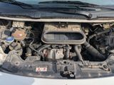 the engine of a car with its hood open and the hood down