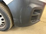 a close up of a car ' s front bumper and tire
