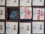 many boxes of screws that are stacked on top of each other