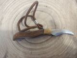 a knife that is laying on top of a piece of wood
