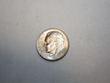 a silver coin with a picture of a man on it