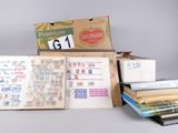 a lot of books and a box of stamps on a table