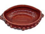 a brown bowl that is sitting on a white surface