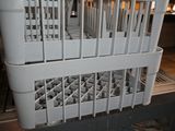 a stack of white plastic baskets on top of a counter