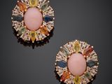 a pair of pink and yellow stone earrings on a black surface