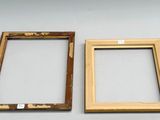 two picture frames that are sitting on a table