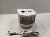 a small air purifier with a cord attached to it