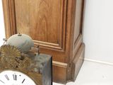 a clock that is sitting next to a clock on the floor