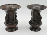 two vases that are sitting next to each other on a table