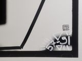 a black and white photo of a clock with graffiti on it