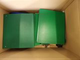 a box with two green folders inside of it