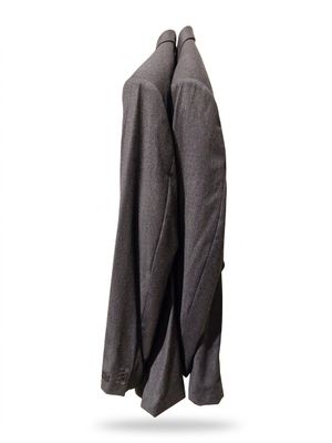 a coat hanging on a clothes rack on a white wall