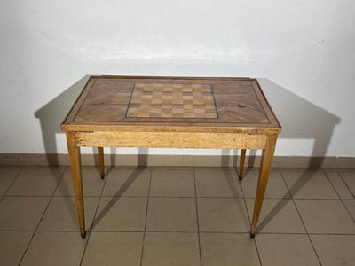 a small wooden table with a chess board on top of it