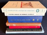 three books stacked on top of each other on a table
