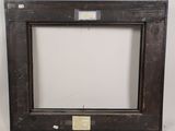 an old wooden frame with a label on it