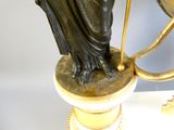 a statue of a woman holding a globe on top of a table