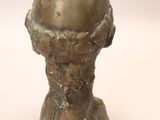 statue of a man ' s head with a sphere in the middle of his head