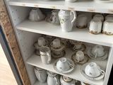 a cabinet with a lot of dishes and cups on it