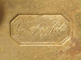a close up of a gold plate with a name engraved on it