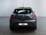 the back of a grey car in a room with a white wall