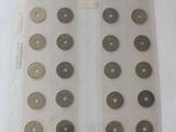 a lot of coins in a plastic bag on a table