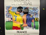 a poster of a couple of soccer players on the wall