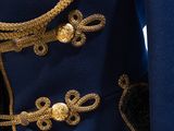 a close up of a blue jacket with gold buttons