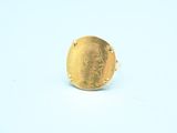 an image of a gold ring on a white surface