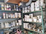 a room with shelves filled with paint and other items