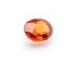 an orange sapphire stone on a white background