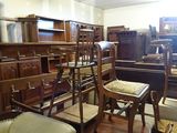 a room with a lot of antique furniture in it