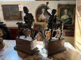 three statues of people riding horses in a room