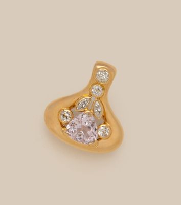 a close up of a pink diamond pendant on a white background