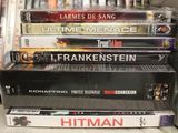 many dvds stacked on top of each other on a shelf
