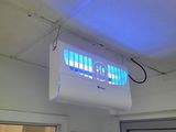 ceiling mounted air conditioner with blue light in a room