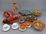 many different types of dishes and cups on the table