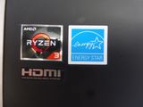a close up of a laptop with stickers on it