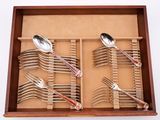 several spoons and forks are in a wooden box with a divider