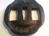 an old iron belt buckle on a white surface