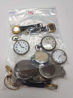 a bag of assorted pocket watches on a table