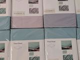many boxes of bedding that are stacked on top of each other