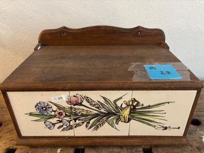 a wooden box with flowers painted on it