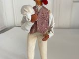 figurine of a man holding a baby in his arms