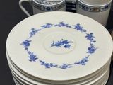 a stack of plates and cups on a table