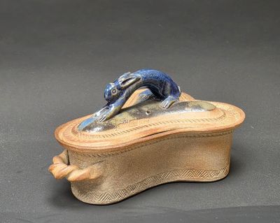 a small box with a cat on it on a table