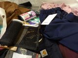 a pile of clothes and other items on the floor