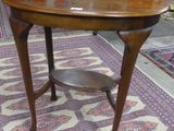 a wooden table with a shelf on it in the middle of a room