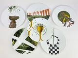 four plates with different designs on them on the wall